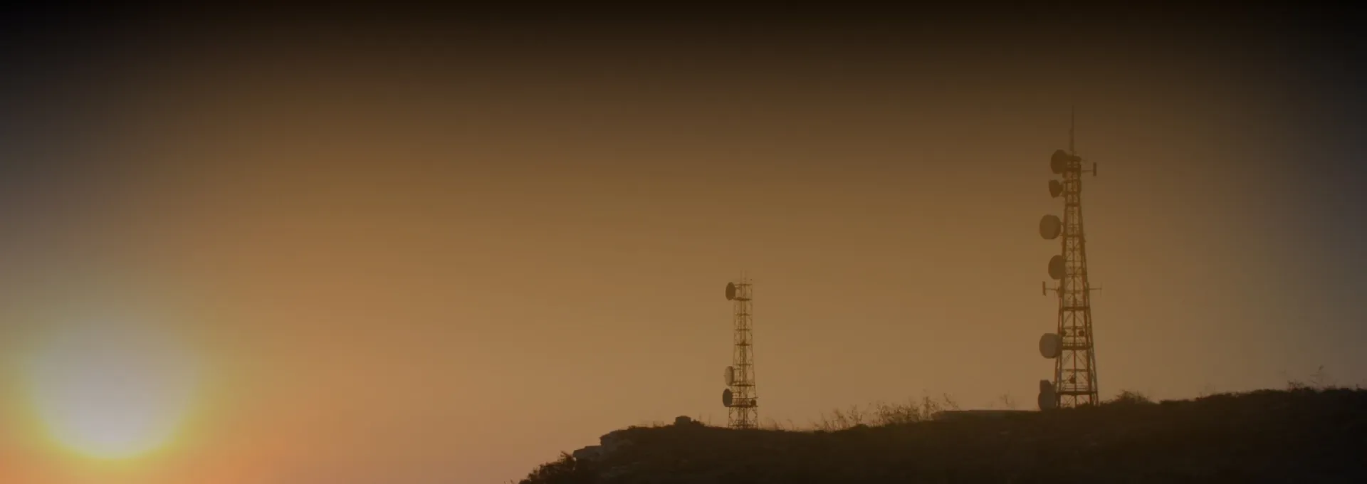 bright sunset banner with two broadcast antennas