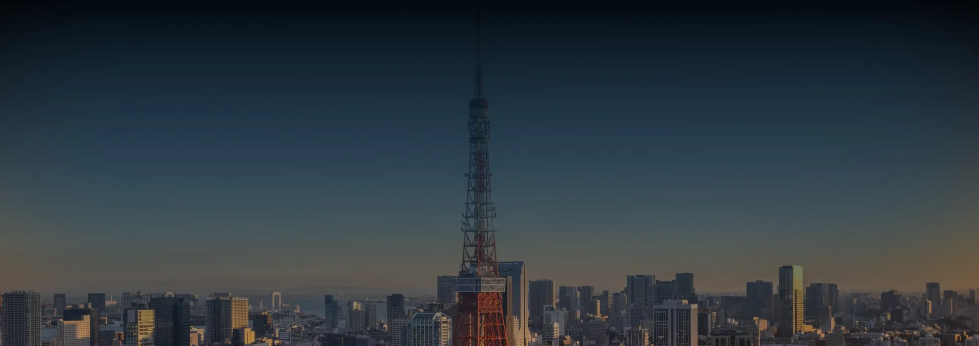 Single red broadcast tower overlooking city