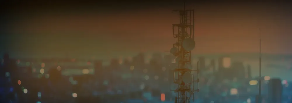 Banner of sunset over city with close up antenna