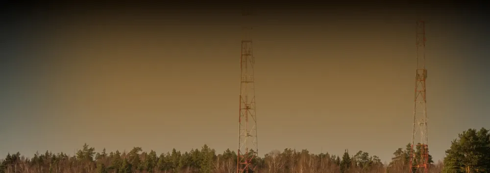 Orange banner with antenna over trees
